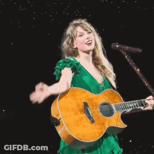 Woman In Green Dress Singing Into Microphone GIF