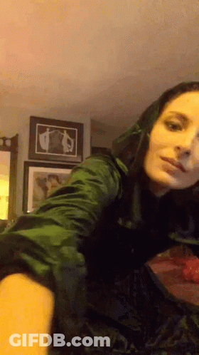Woman In Green Dress Taking Selfie In Mirror GIF