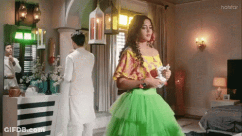 Woman In Green Dress With Man In White Suit GIF