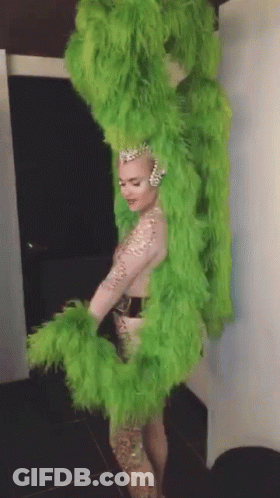 Woman In Green Feathered Costume GIF