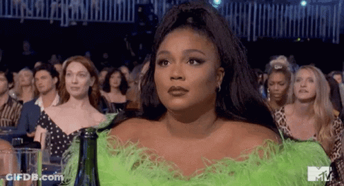 Woman In Green Feathered Dress At Concert GIF