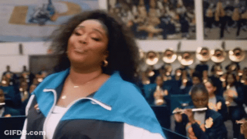 Woman In Green Feathered Dress At Concert GIF