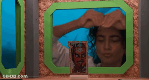 Woman In Green Frame Holding RB Card GIF