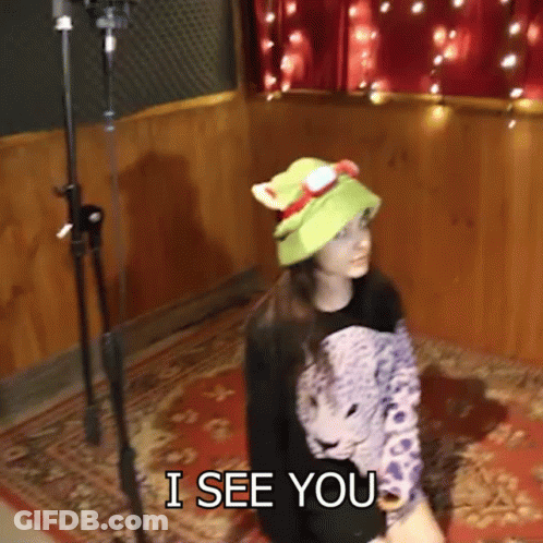 Woman In Green Hat And Leopard Shirt Says I See You GIF