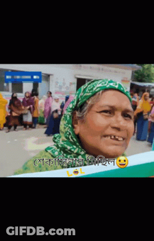 Woman In Green Head Scarf Smiling Holding Lol Sign GIF