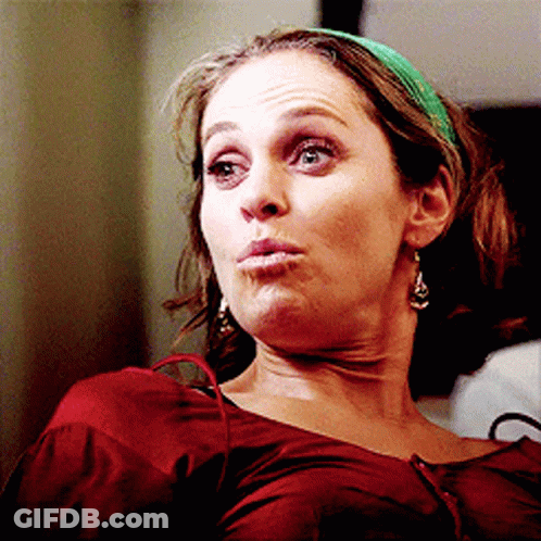 Woman In Green Headband And Earrings Making A Face GIF