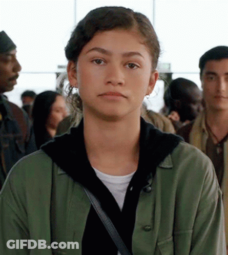 Woman In Green Jacket And Black Hoodie Crowd GIF