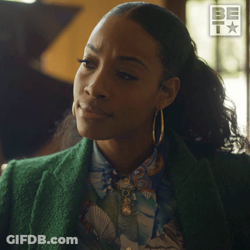 Woman In Green Jacket And Hoop Earrings Saying Sure GIF