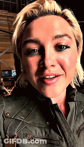 Woman In Green Jacket And Suspenders Close Up GIF