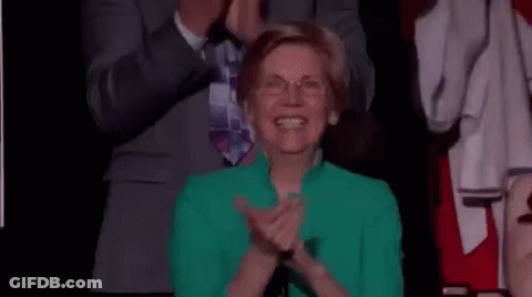 Woman In Green Jacket Applauding In Crowd GIF