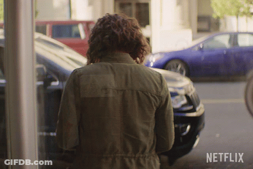 Woman In Green Jacket At Netflix Logo GIF