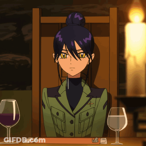 Woman In Green Jacket At Table With Wine Glasses And Candle GIF