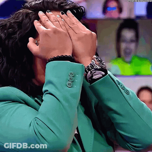 Woman In Green Jacket Covering Face With Watch GIF