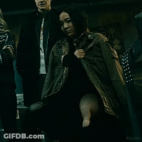 Woman In Green Jacket Holding Baby's Leg GIF