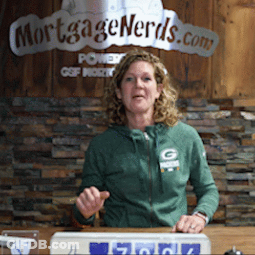 Woman In Green Jacket In Front Of Mortgage Nerds Sign GIF