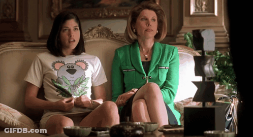 Woman In Green Jacket Next To Woman With Koala Shirt GIF