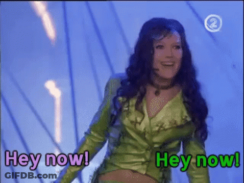 Woman In Green Jacket Says Hey Now GIF