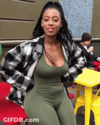 Woman In Green Jumpsuit And Plaid Jacket GIF
