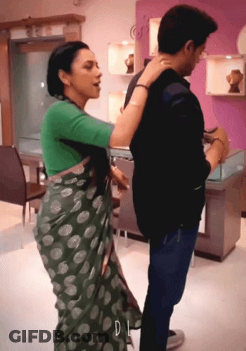 Woman In Green Polka Dot Saree Next To Man GIF