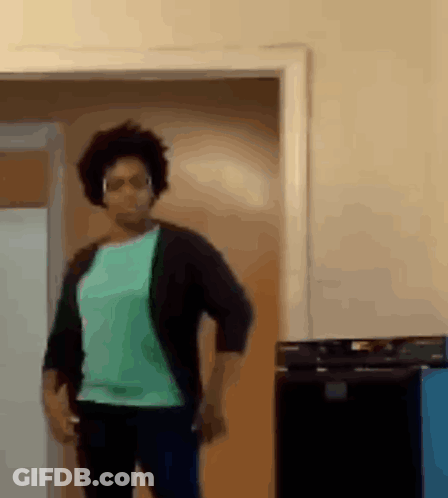 Woman In Green Shirt And Black Cardigan Dancing GIF
