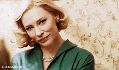 Woman In Green Shirt And Pearl Necklace Making Funny Face GIF