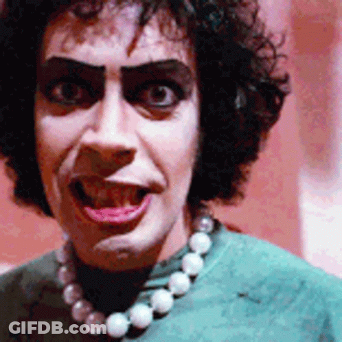 Woman In Green Shirt And Pearl Necklace GIF