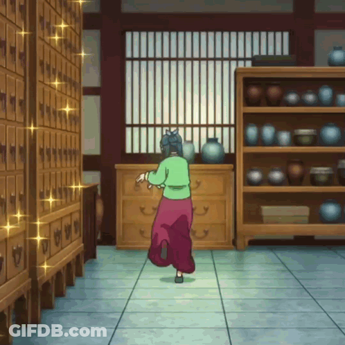 Woman In Green Shirt And Pink Skirt In Room With Shelves GIF