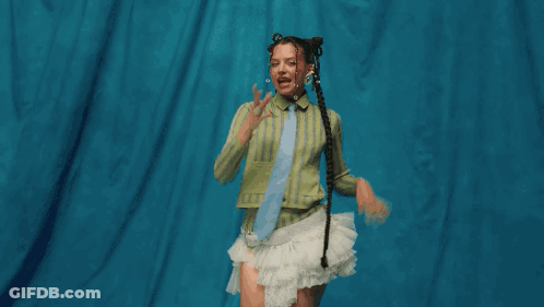Woman In Green Shirt And White Skirt In Grassy Field GIF