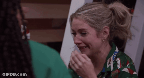 Woman In Green Shirt Crying Man Holding Hand GIF