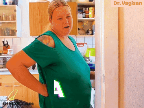 Woman In Green Shirt In Front Of Dr Vagisan Sign GIF