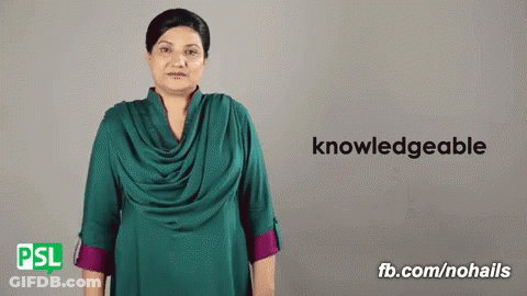 Woman In Green Shirt In Front Of Sign Saying Knowledgeable GIF