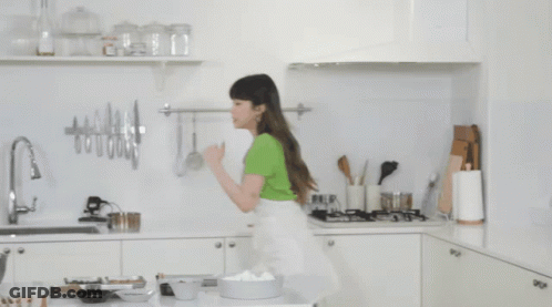 Woman In Green Shirt In Kitchen GIF