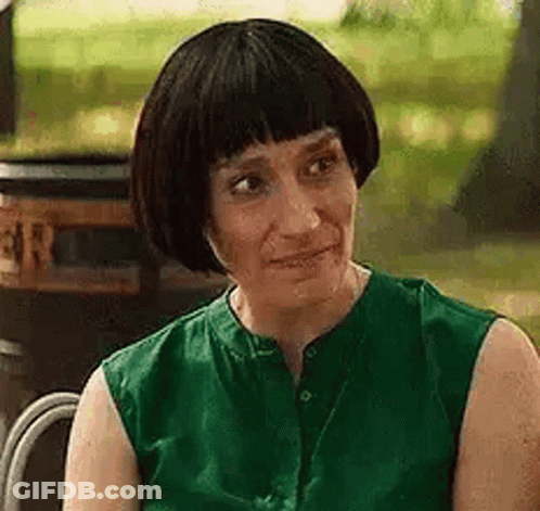 Woman In Green Shirt Sitting In Chair GIF