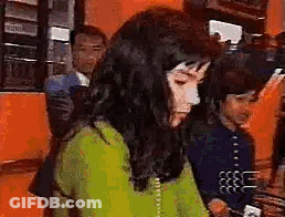 Woman In Green Shirt Sitting With Man In Blue Shirt GIF