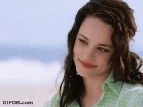 Woman In Green Shirt Smiling On Beach GIF