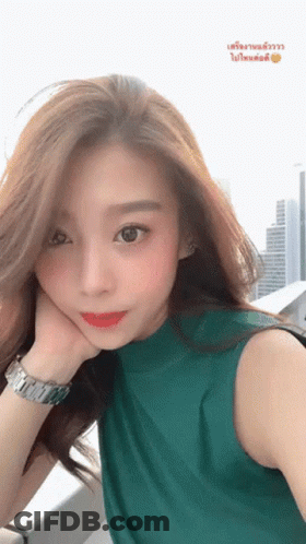 Woman In Green Shirt Taking Selfie GIF