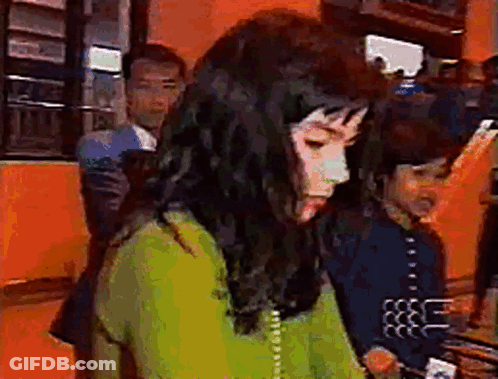 Woman In Green Shirt Talking On Telephone GIF