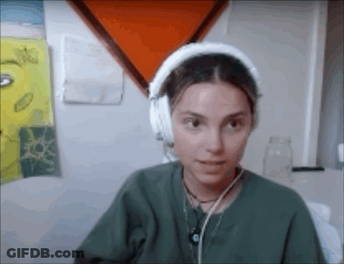 Woman In Green Shirt With Headphones GIF