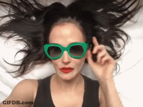 Woman In Green Sunglasses And Red Lips Lying GIF