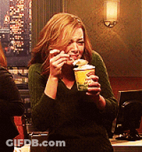 Woman In Green Sweater Holding Cup Of Food GIF