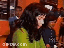 Woman In Green Sweater Sitting With Man In Suit GIF