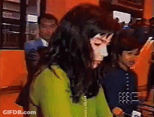Woman In Green Sweater Talking On Phone GIF