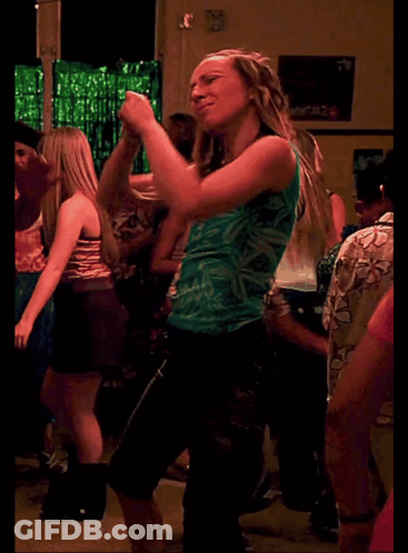 Woman In Green Tank Top Dancing In Crowd GIF