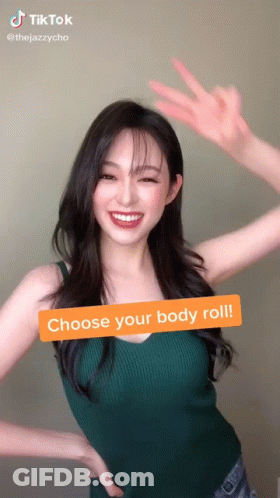Woman In Green Tank Top Making Peace Sign GIF