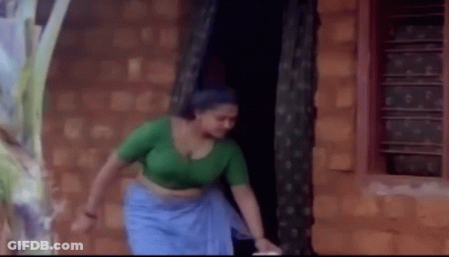 Woman In Green Top And Blue Skirt GIF