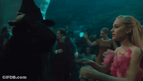 Woman In Green Witch Costume Hugging Another Woman GIF