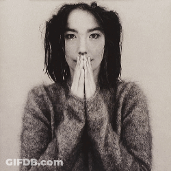 Woman In Grey Sweater Covering Mouth GIF