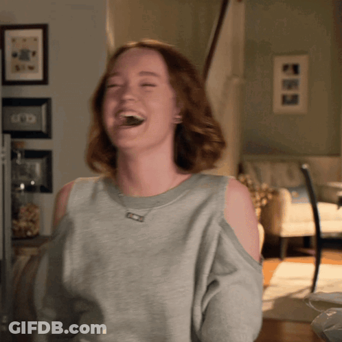 Woman In Grey Sweater Laughing GIF