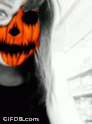 Woman In Halloween Mask With Pumpkin Face GIF