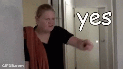 Woman In Hallway With Towel Pointing Yes GIF